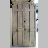Narrow wooden double door.
