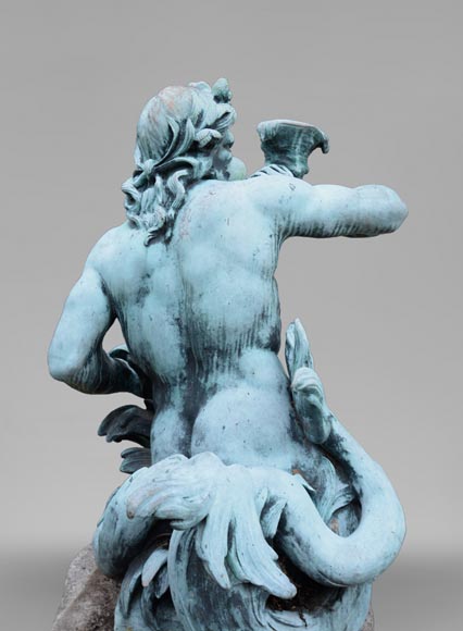 Important Louis XIV style pair of Tritons sounding a conch shell in bronze with green patina