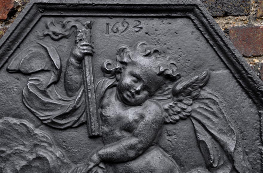 Antique fireback dated 1693 with winged putto holding a torch-1