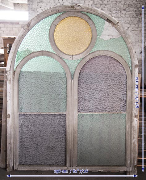 Arched wooden window frames and coloured glass-11