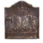 An old 18th century fireback with coat of arms and sitting lions