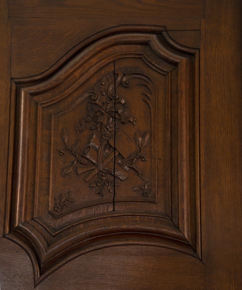 Double door in carved oak decorated with military trophies-3
