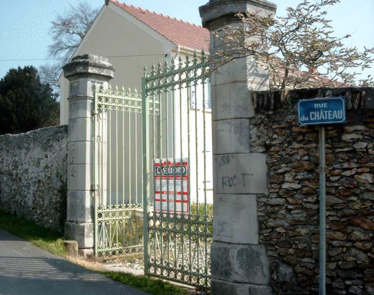 Wrought_iron_entrance_gate_with_stone_posts.jpg