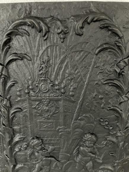 Cast iron fireback with putti firing a cannon-3
