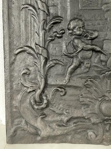 Cast iron fireback with putti firing a cannon-5