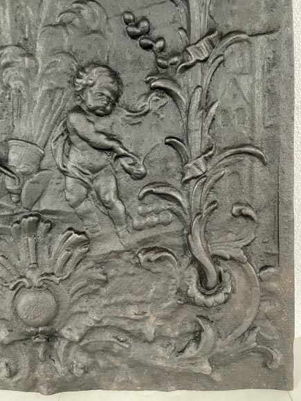 Cast iron fireback with putti firing a cannon-7