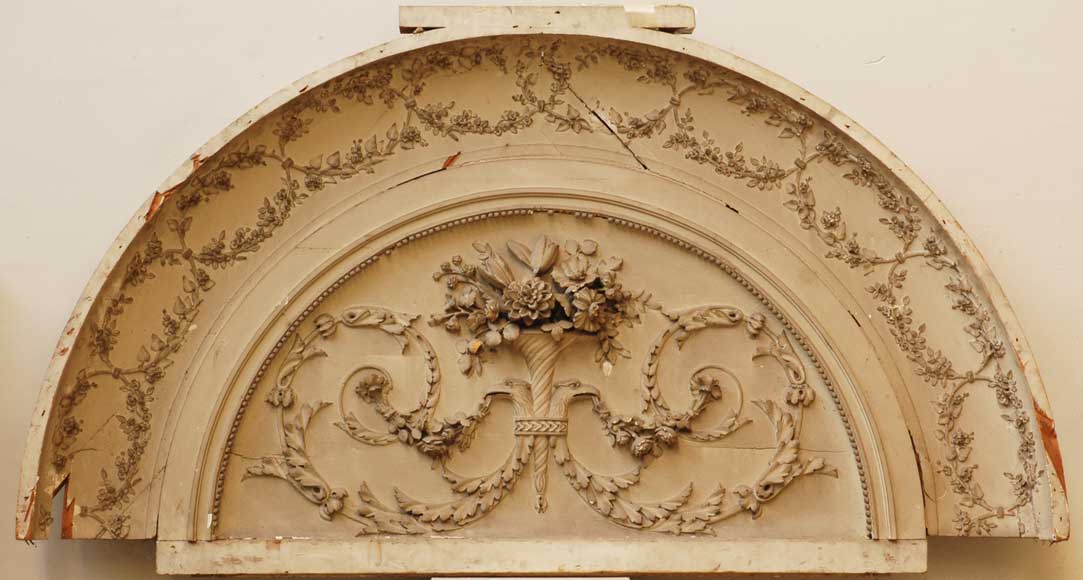 Carved_wood_and_stucco_pediment.jpg