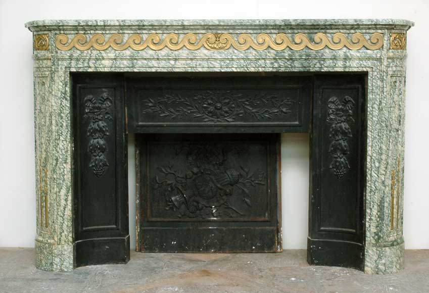Louis_XVI_mantel_Vert_d_Estours_marble_with_bronzes.jpg