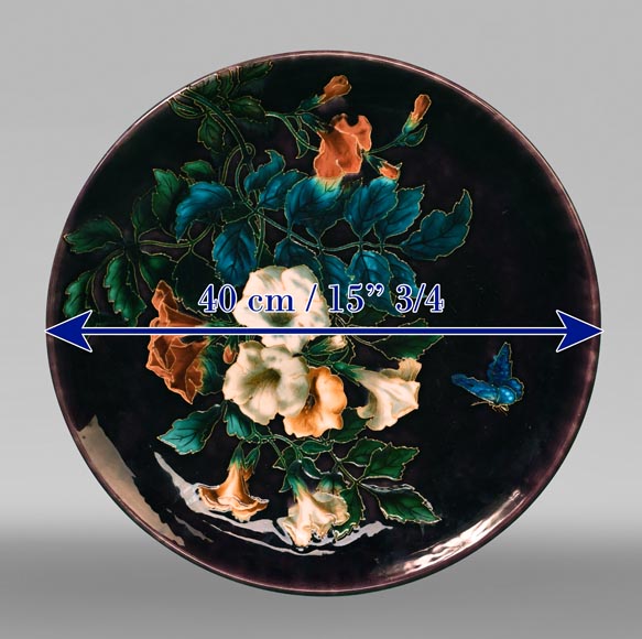 Théodore DECK, circular dish decorated with flowers and butterfly on an eggplant background, after 1870-7