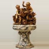 Gilded garden fountain with putti and swan