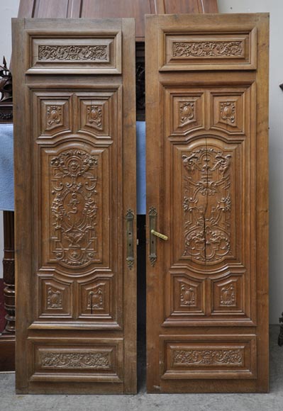 False pair of antique  carved oak doors from the 19th century-0