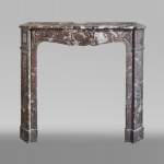 Antique Louis XV style fireplace in Rouge du Nord marble