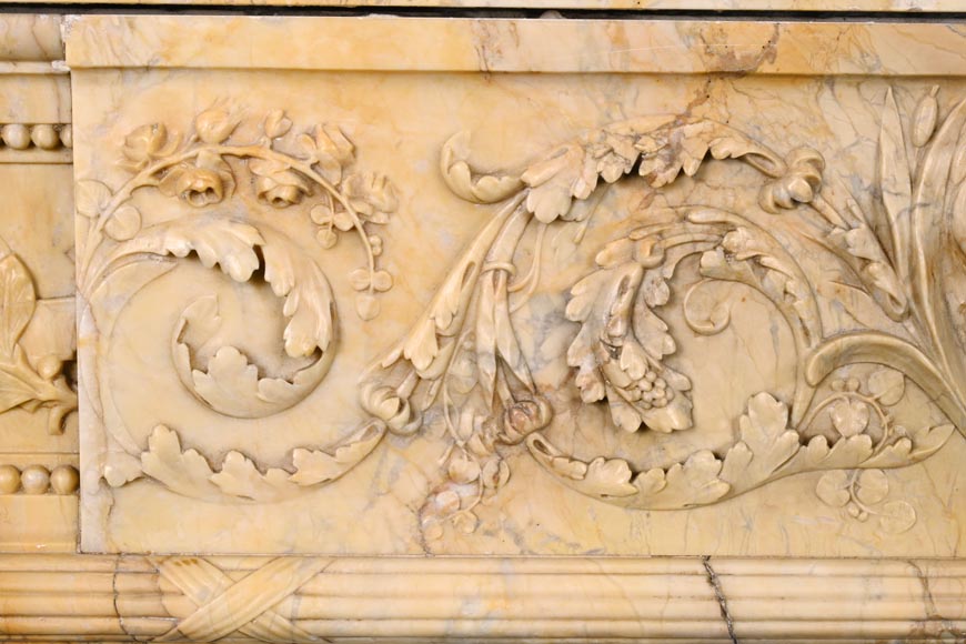 Large Louis XVI style mantel in yellow Sienna marble with entablature adorned with the head of Apollo and arrow heads on the jambs-3