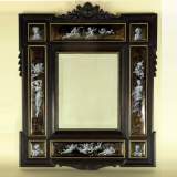 Mirror with putti, enameled grisaille on gold base and blackened wood - Reference 9214 Width 2' 1'' ⅝ 65cm Height 2' 7'' ⅛ 79cm Mirror with putti, enameled grisaille on gold base and blackened wood - Reference 9214 Width 2' 1'' ⅝ 65cm Height 2' 7'' ⅛ 79cm