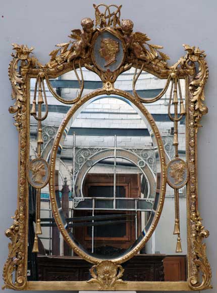Gilded_overmantel_mirror_with_medallions_and_putti.jpg