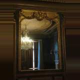 Antique Gilded mirror with putti and mask of woman