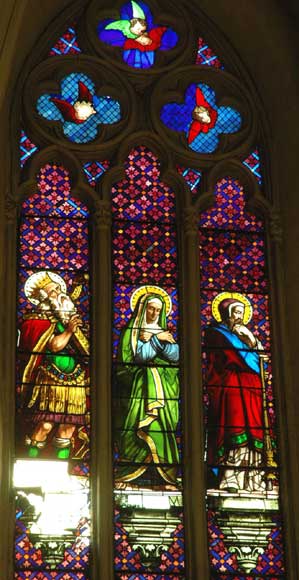 Stained glass window from a chapel with Mary as central figure Stained glass window from a chapel with Mary as central figure-1