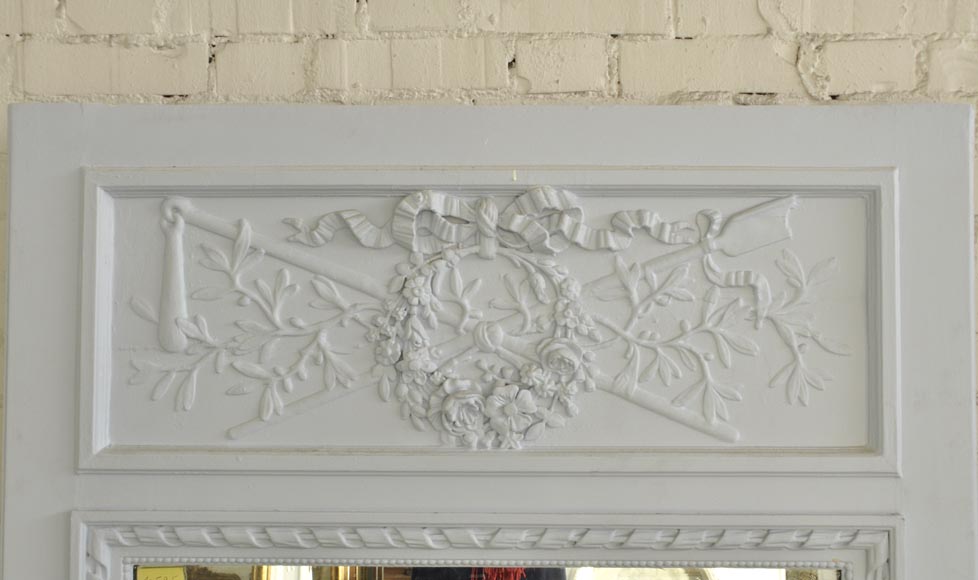 Antique Louis XVI style overmantel mirror with wreaths and masses of weapons, wood and stucco painted blue Antique Louis XVI style overmantel mirror with wreaths and masses of weapons, wood and stucco painted blue-1