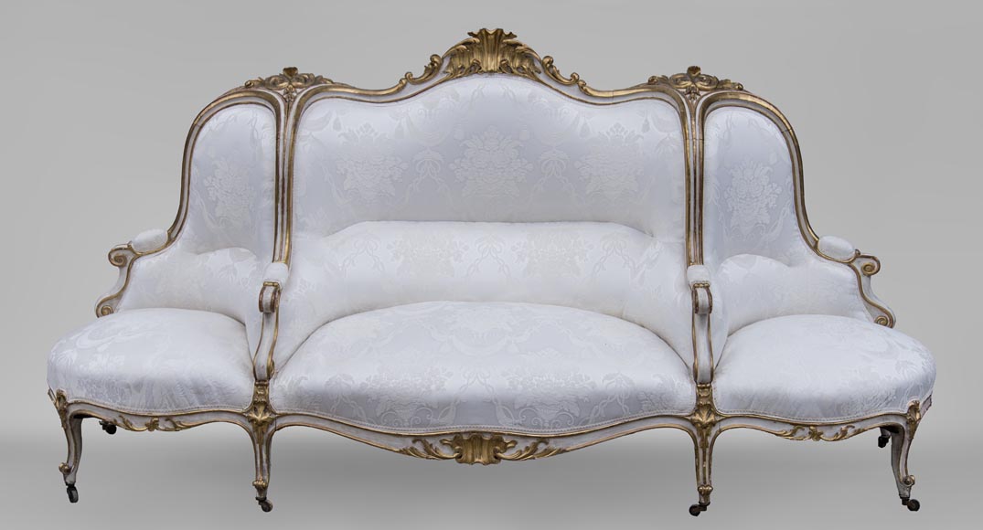 A large Louis XV style bench made out of gilded wood A large Louis XV style bench made out of gilded wood-0