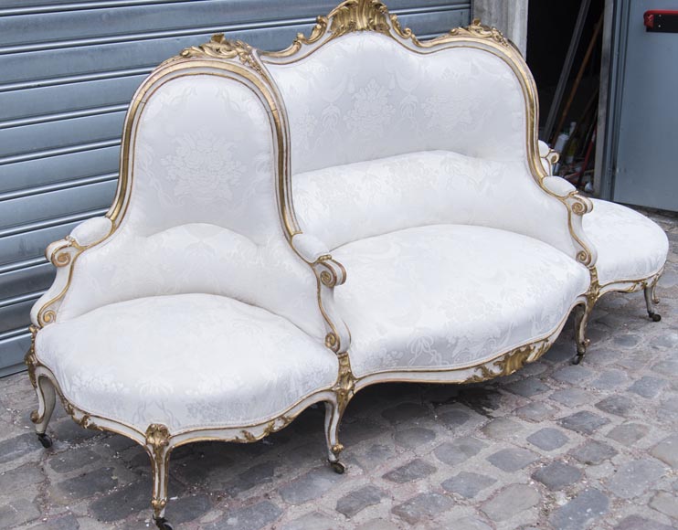 A large Louis XV style bench made out of gilded wood A large Louis XV style bench made out of gilded wood-1