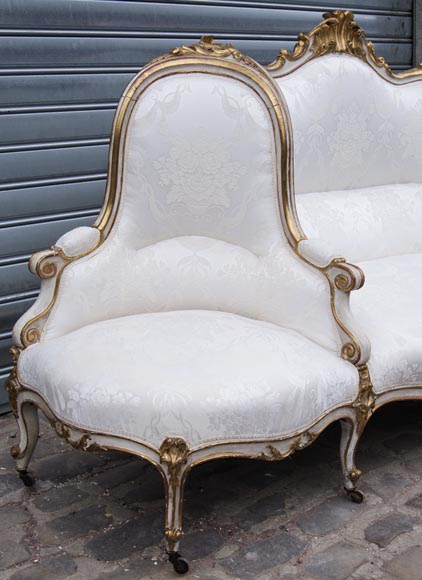 A large Louis XV style bench made out of gilded wood A large Louis XV style bench made out of gilded wood-3