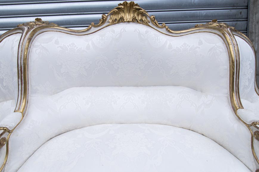 A large Louis XV style bench made out of gilded wood A large Louis XV style bench made out of gilded wood-10