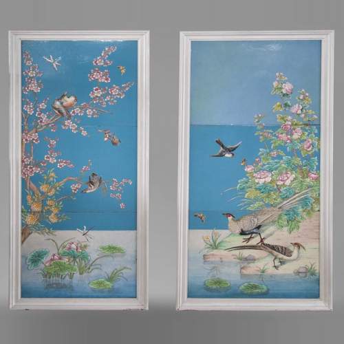 A pair of ceramic panels with birds in a lacustrine scenery signed