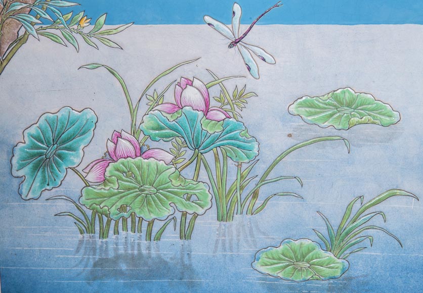 A pair of ceramic panels with birds in a lacustrine scenery signed A pair of ceramic panels with birds in a lacustrine scenery signed