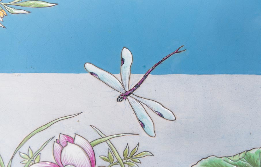 A pair of ceramic panels with birds in a lacustrine scenery signed A pair of ceramic panels with birds in a lacustrine scenery signed