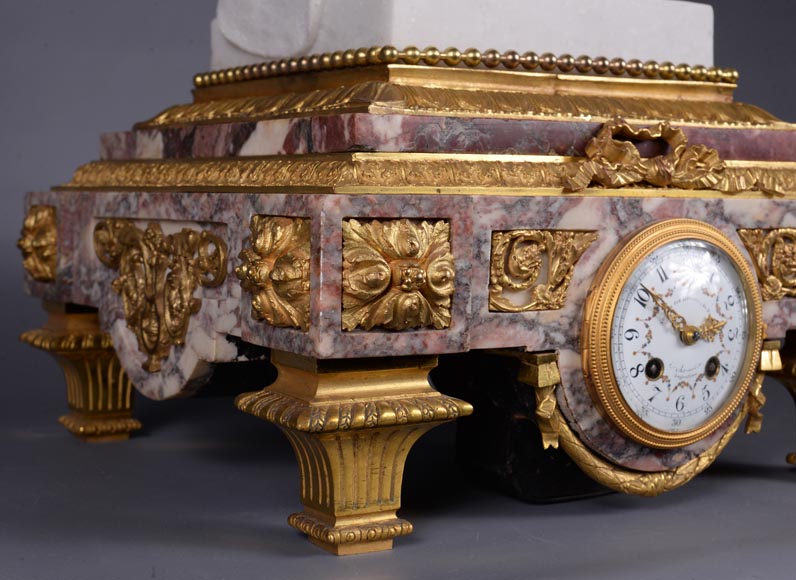 Peach blossom marble and gilt bronze clock surmounted by a statuary white marble   sculpture representing Phryne in front of his judges signed  Peach blossom marble and gilt bronze clock surmounted by a statuary white marble   sculpture representing Phryne in front of his judges signed