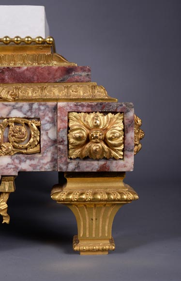 Peach blossom marble and gilt bronze clock surmounted by a statuary white marble   sculpture representing Phryne in front of his judges signed  Peach blossom marble and gilt bronze clock surmounted by a statuary white marble   sculpture representing Phryne in front of his judges signed