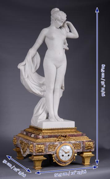 Peach blossom marble and gilt bronze clock surmounted by a statuary white marble   sculpture representing Phryne in front of his judges signed  Peach blossom marble and gilt bronze clock surmounted by a statuary white marble   sculpture representing Phryne in front of his judges signed