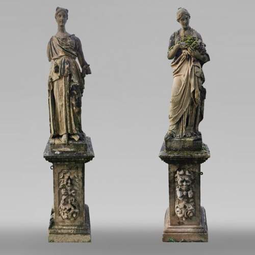 Set of two stone sculptures representing female figures dressed as antique mid-19th century