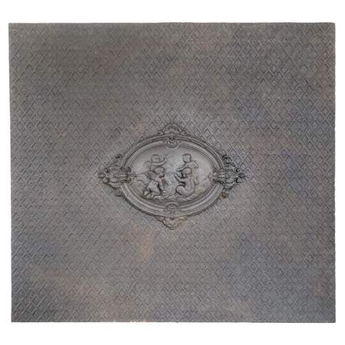 Cast iron fireback with a Putti decoration