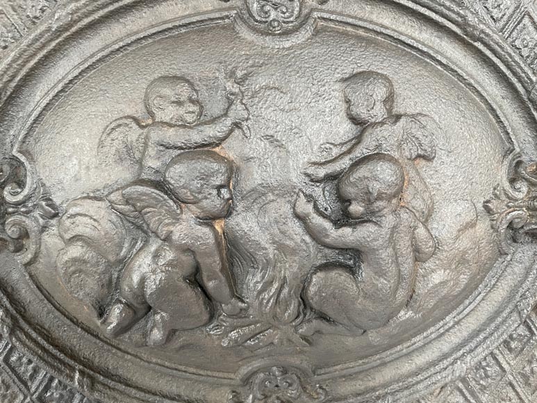 Cast iron fireback with a Putti decoration  Cast iron fireback with a Putti decoration -2