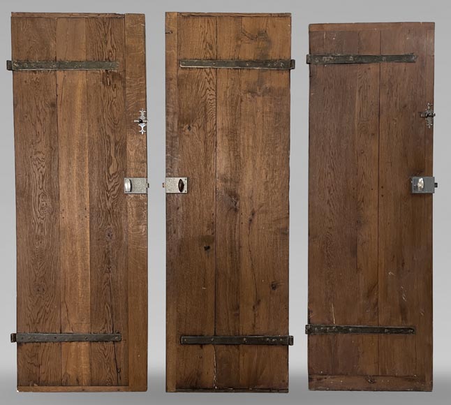 Series of three antique oak doors with their metal hinge Series of three antique oak doors with their metal hinge-0