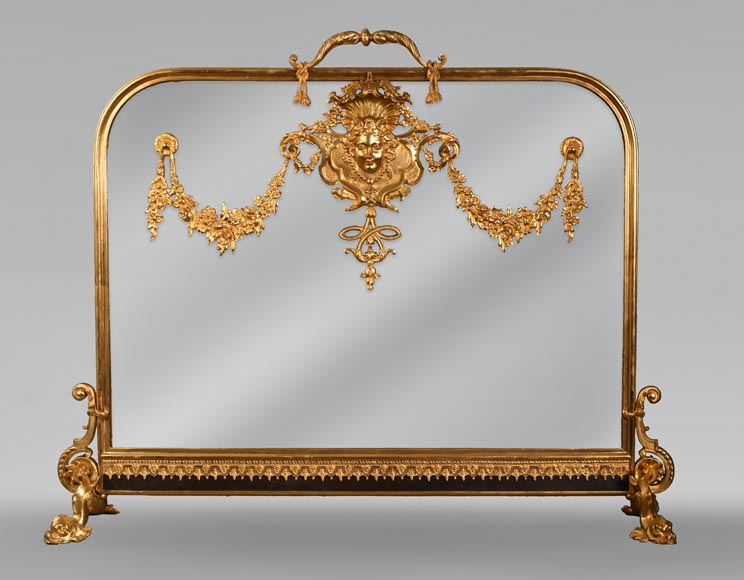 Napoleon III style fireback with woman's mask and garland of flowers in gilded bronze and glass. Napoleon III style fireback with woman's mask and garland of flowers in gilded bronze and glass.-0