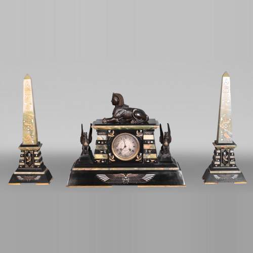 Egyptian Revival mantel garniture in black marble, green onyx, and gilt bronze