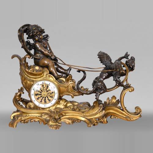 Rococo style clock with Louis XV monogram, gilt and patinated bronze