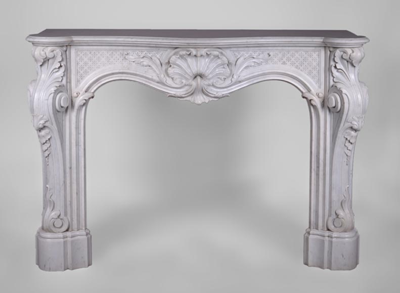 Beautiful antique Louis XV style fireplace with opulent decor in white Carrara marble Beautiful antique Louis XV style fireplace with opulent decor in white Carrara marble-0