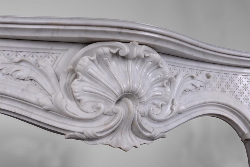 Beautiful antique Louis XV style fireplace with opulent decor in white Carrara marble Beautiful antique Louis XV style fireplace with opulent decor in white Carrara marble-1