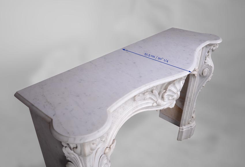 Beautiful antique Louis XV style fireplace with opulent decor in white Carrara marble Beautiful antique Louis XV style fireplace with opulent decor in white Carrara marble-12