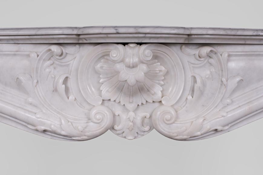 Beautiful antique Louis XV style fireplace with rich decor in white Carrara marble Beautiful antique Louis XV style fireplace with rich decor in white Carrara marble-1