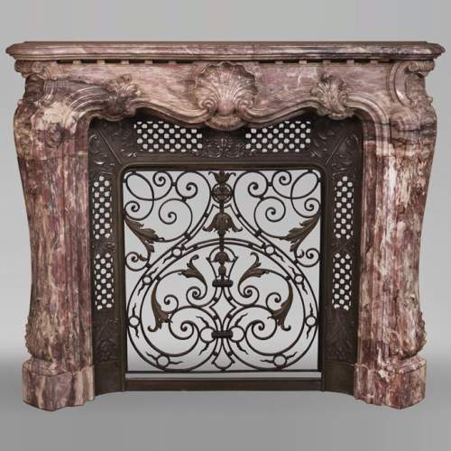 Very beautiful antique Louis XV style opulent fireplace made out of Fleur de Pêcher marble