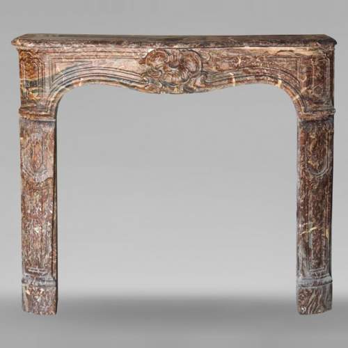 Louis XV period mantel in Rouge Royal marble adorned with a shell