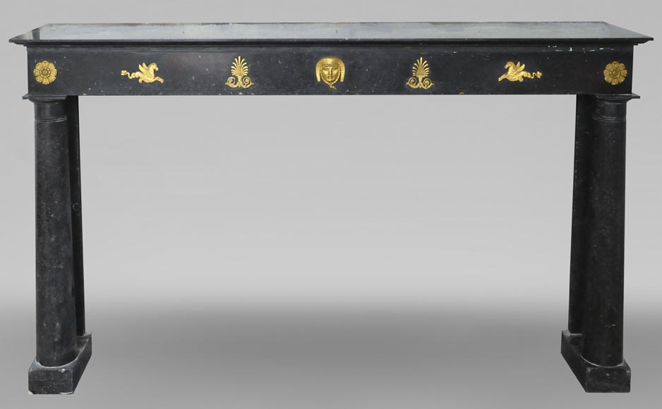 An antique Empire fireplace made out of black marble, witrh bronze ornaments and detached columns An antique Empire fireplace made out of black marble, witrh bronze ornaments and detached columns-0