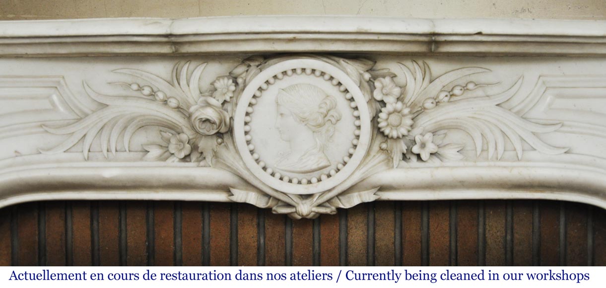 Antique Napoleon III fireplace with a woman's profile decoration in a medallion Antique Napoleon III fireplace with a woman's profile decoration in a medallion-1