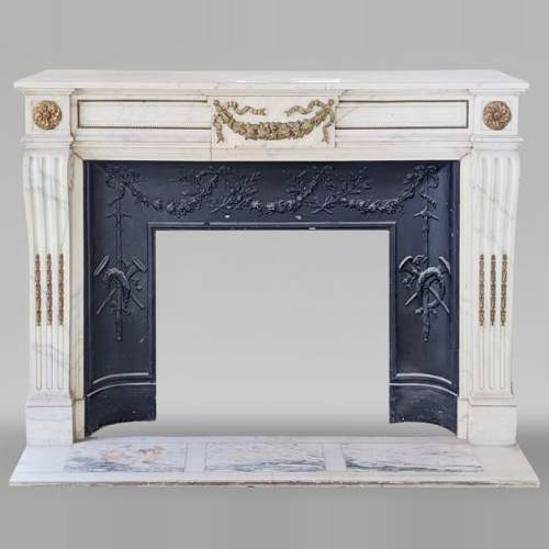 Louis XVI style mantel in semi-statuary Carrara marble with garland of flowers and vine leaves