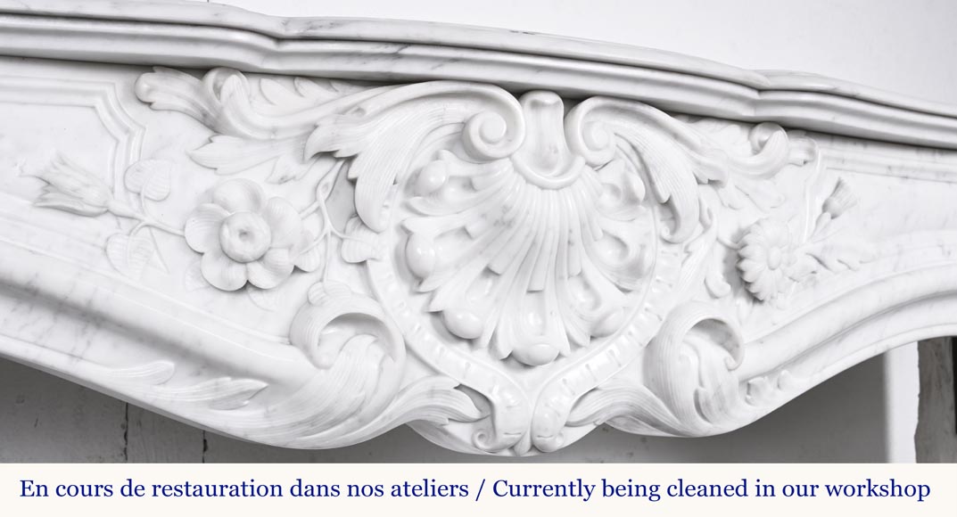 A highly sculpted Louis XV style fireplace in Carrara marble, decorated with a shell motif. A highly sculpted Louis XV style fireplace in Carrara marble, decorated with a shell motif.-2