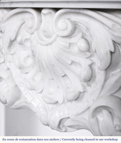 A highly sculpted Louis XV style fireplace in Carrara marble, decorated with a shell motif. A highly sculpted Louis XV style fireplace in Carrara marble, decorated with a shell motif.-3